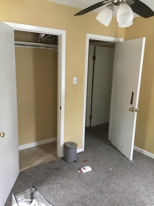 unfurnished bedroom featuring a ceiling fan, carpet, and a closet