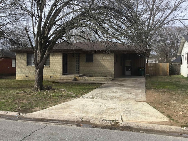 ranch-style home featuring driveway, an attached carport, crawl space, fence, and brick siding