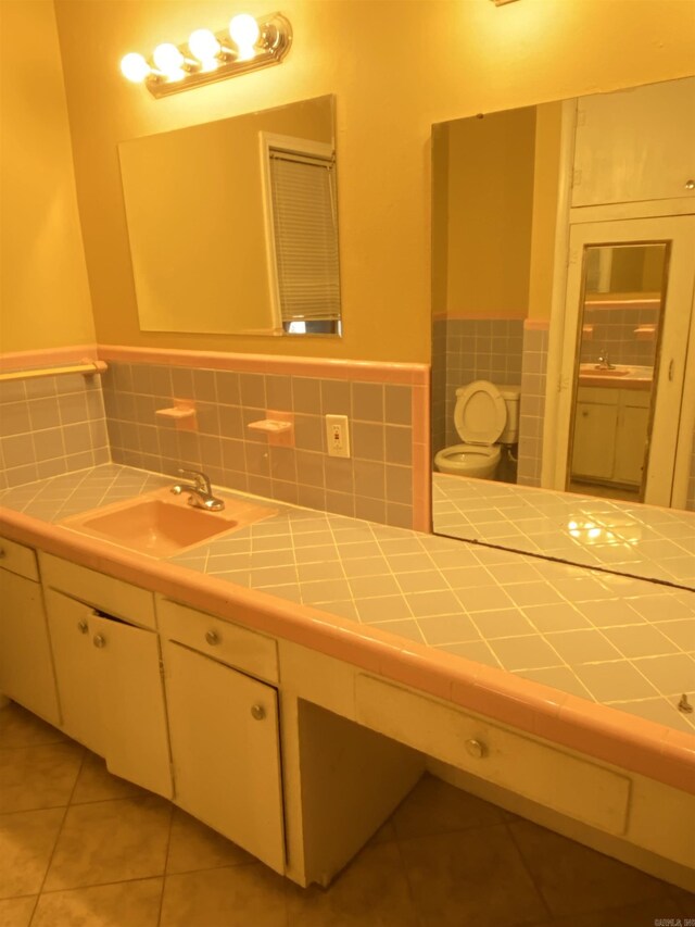 bathroom with tile patterned flooring and vanity