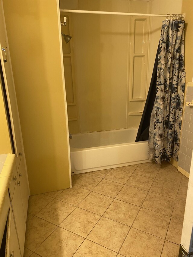 full bath featuring shower / bath combo with shower curtain and tile patterned floors