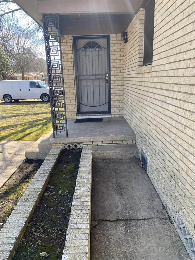 property entrance with brick siding