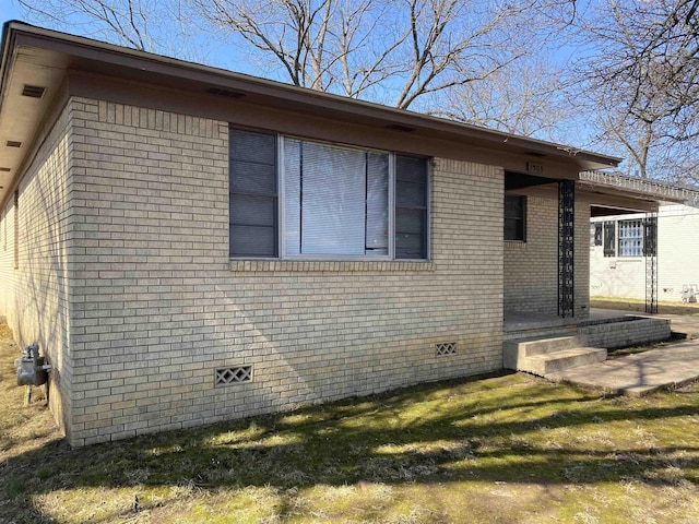 exterior space with crawl space and brick siding