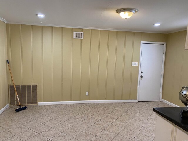 interior space featuring light tile patterned floors, stairs, visible vents, and crown molding