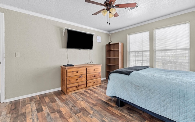 bedroom with visible vents, dark wood finished floors, a textured wall, a textured ceiling, and crown molding