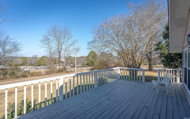 wooden deck featuring a yard