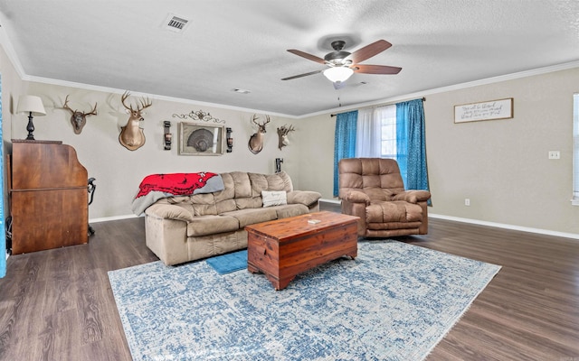 living area with crown molding, a textured ceiling, visible vents, and dark wood-type flooring