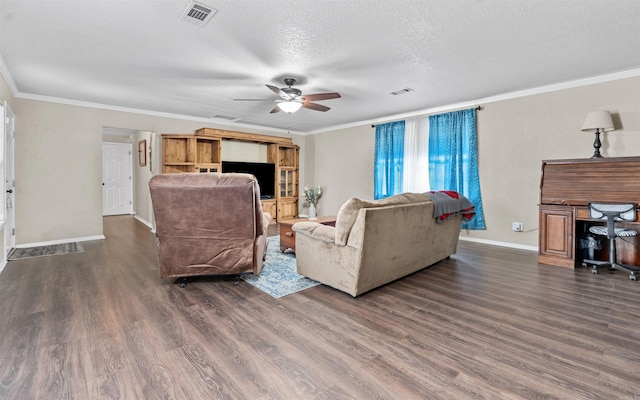 living room featuring a textured ceiling, visible vents, baseboards, dark wood finished floors, and crown molding