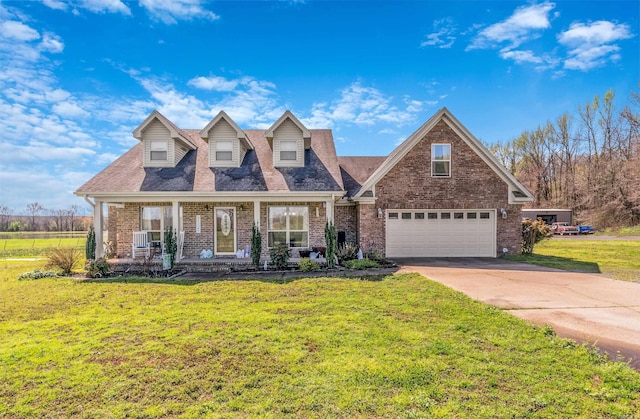 view of front of property with a garage, a front yard, covered porch, and brick siding