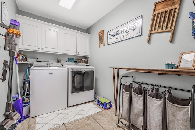 laundry room featuring cabinet space, washing machine and clothes dryer, and light tile patterned floors