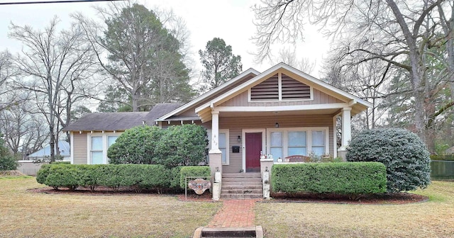 view of front facade featuring a porch, a front lawn, and board and batten siding