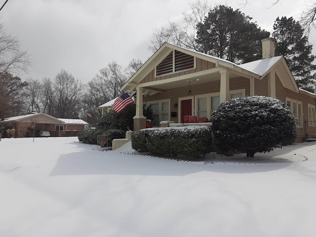 view of front of property featuring board and batten siding and a chimney