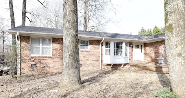 exterior space with crawl space and brick siding