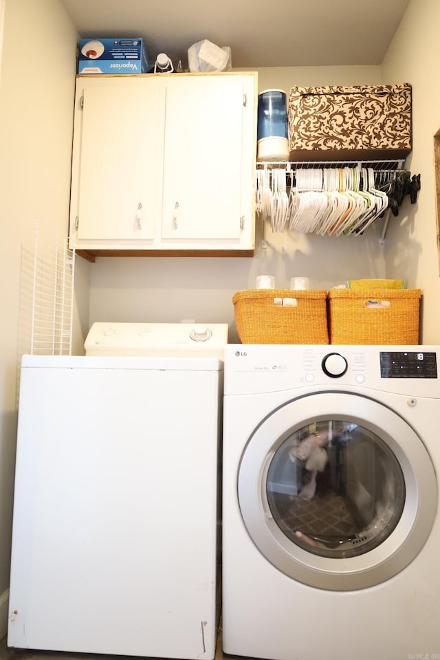 washroom featuring cabinet space and washer and dryer