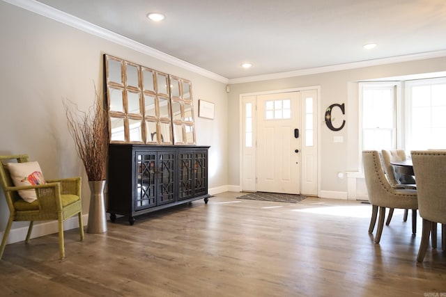 entryway featuring baseboards, ornamental molding, and dark wood finished floors