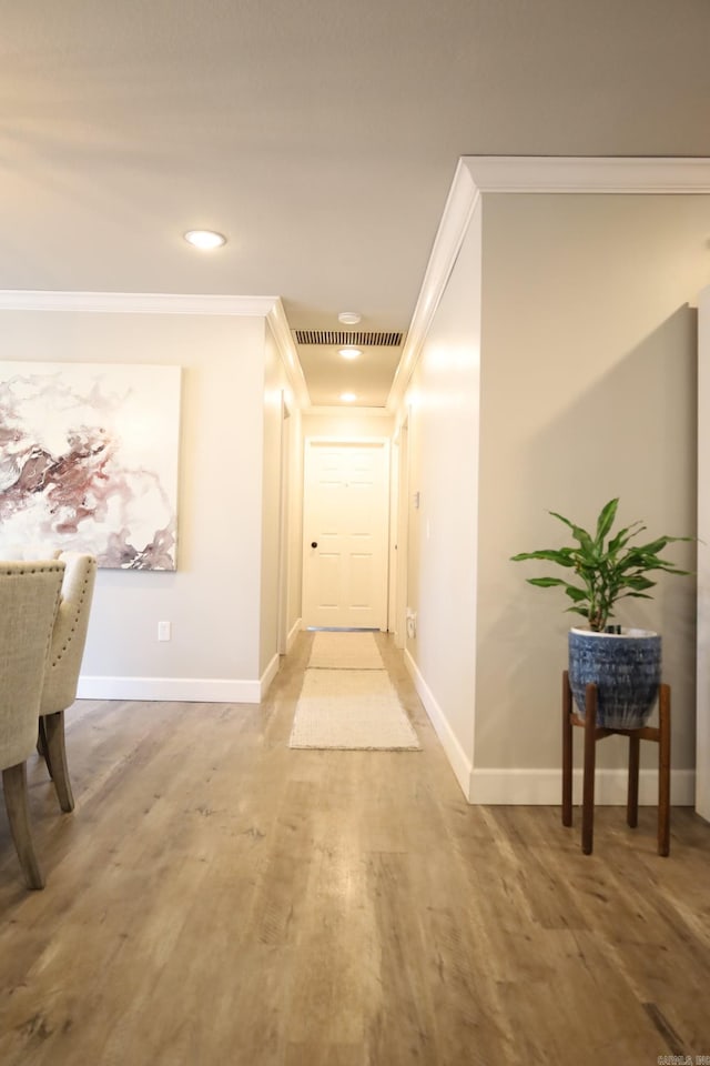 hall with recessed lighting, crown molding, baseboards, and wood finished floors