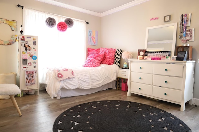 bedroom with ornamental molding, white refrigerator with ice dispenser, and dark wood-style floors