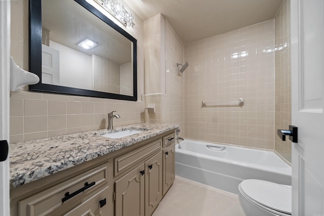 bathroom with decorative backsplash, toilet,  shower combination, tile patterned flooring, and vanity