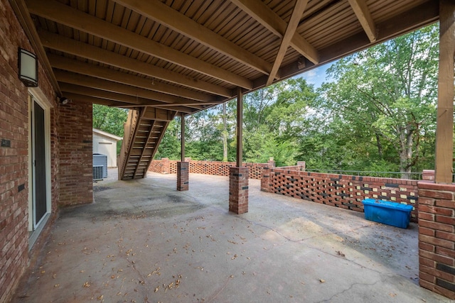 view of patio with central air condition unit, stairs, and fence