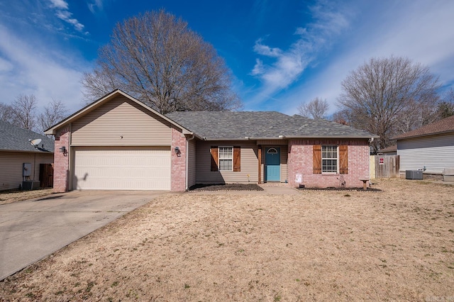 ranch-style house with a garage, driveway, a shingled roof, central AC, and brick siding