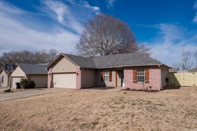 ranch-style home with a garage, brick siding, driveway, roof with shingles, and a gate