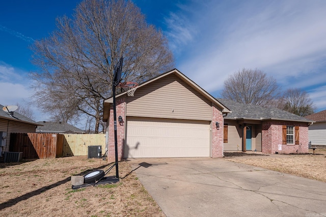 single story home featuring brick siding, an attached garage, central AC unit, fence, and driveway