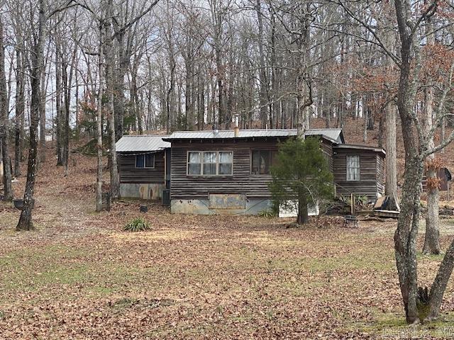 view of front of property with crawl space and metal roof