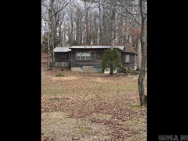 view of front of house featuring crawl space and metal roof