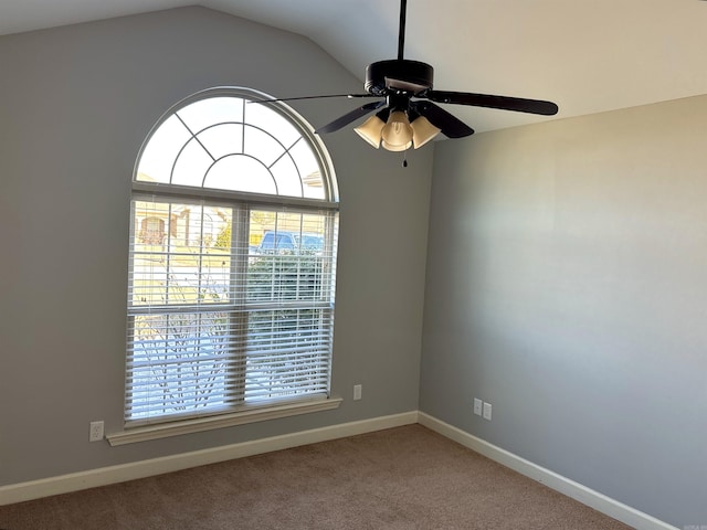 spare room with vaulted ceiling, carpet floors, and a wealth of natural light