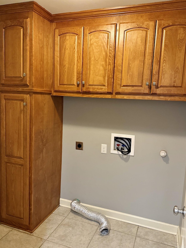 washroom with hookup for a washing machine, hookup for an electric dryer, cabinet space, and baseboards