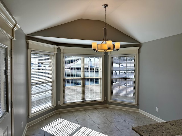 unfurnished dining area with baseboards, vaulted ceiling, a notable chandelier, and light tile patterned flooring