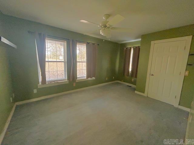 unfurnished bedroom featuring carpet flooring, ceiling fan, and baseboards