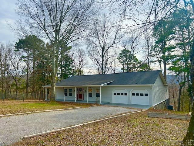 ranch-style home featuring a garage and driveway