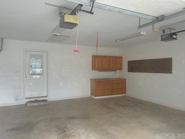 garage featuring baseboards and a garage door opener