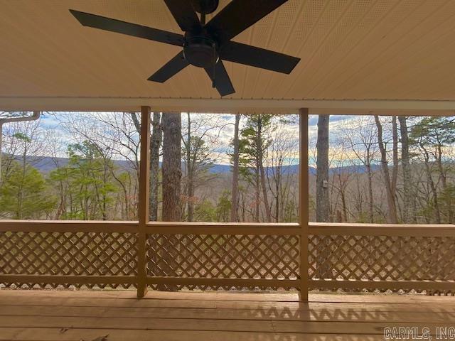 exterior space featuring a mountain view and a ceiling fan