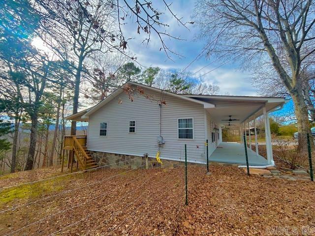 back of property featuring stairs and ceiling fan