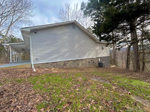 view of home's exterior with a carport and central air condition unit