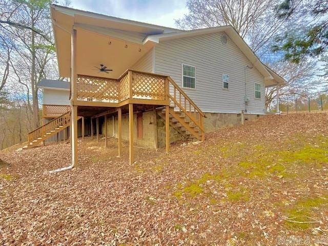 back of property featuring crawl space, stairs, and a wooden deck