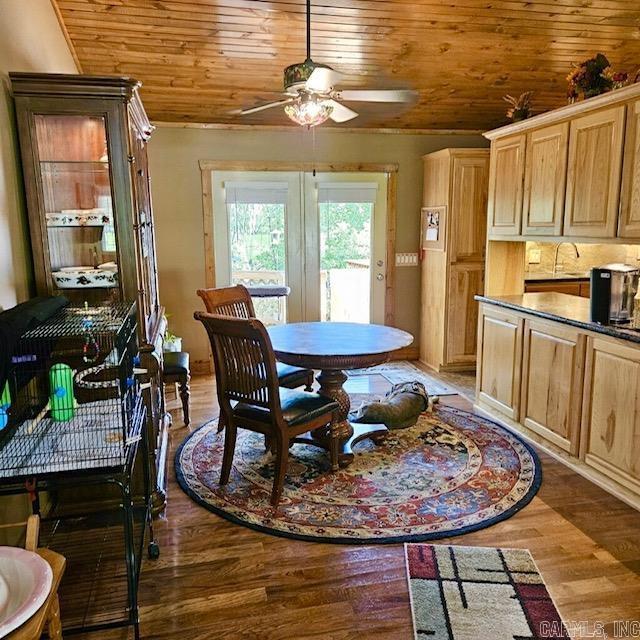 dining space featuring wood finished floors, wood ceiling, and a ceiling fan