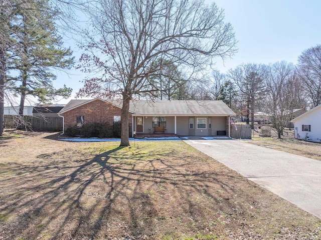 single story home with fence, concrete driveway, and a front yard