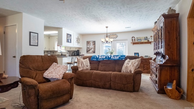 living room with light carpet, a textured ceiling, and a notable chandelier