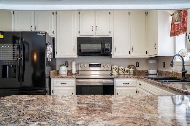 kitchen featuring stone counters, white cabinetry, a sink, and black appliances