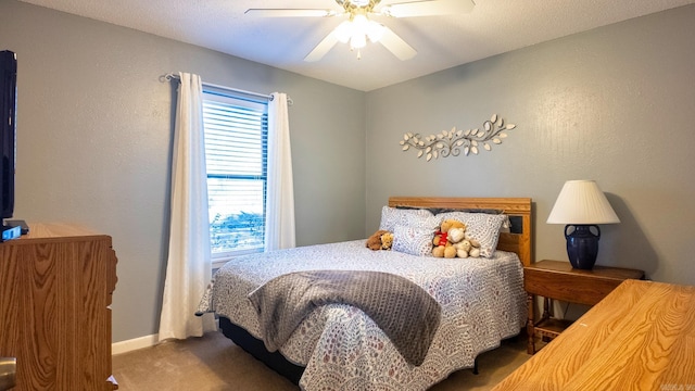 bedroom with ceiling fan, carpet, and baseboards