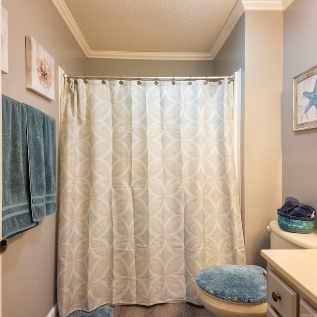 full bath with ornamental molding, vanity, and a textured ceiling