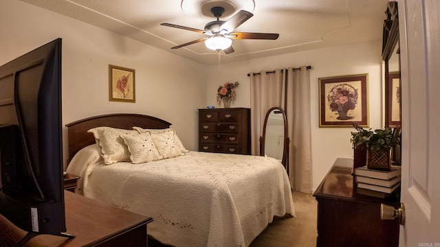 bedroom with dark colored carpet and a ceiling fan