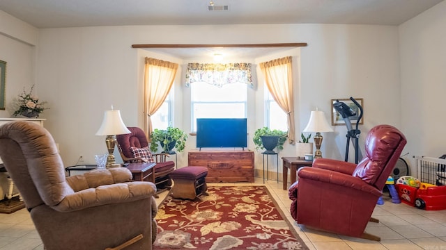 living room featuring visible vents and light tile patterned flooring