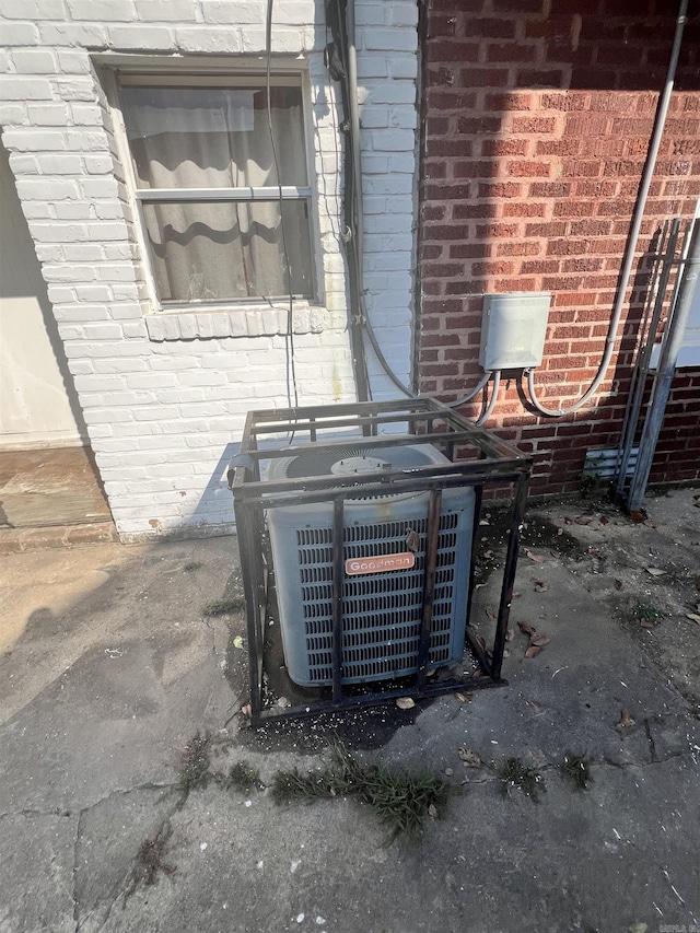 details featuring brick siding and central AC unit