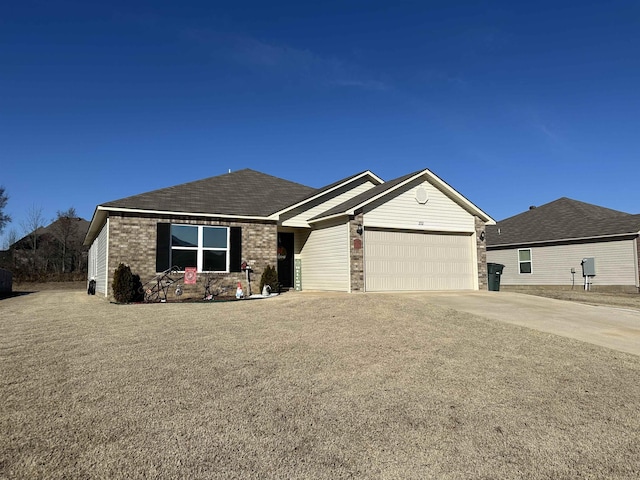 single story home featuring a garage, concrete driveway, and brick siding