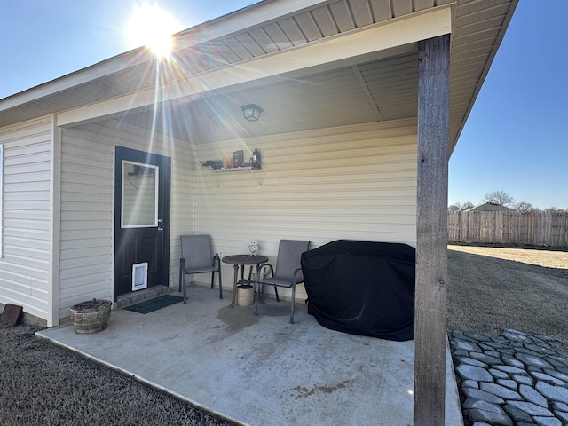 view of patio / terrace with a grill and fence