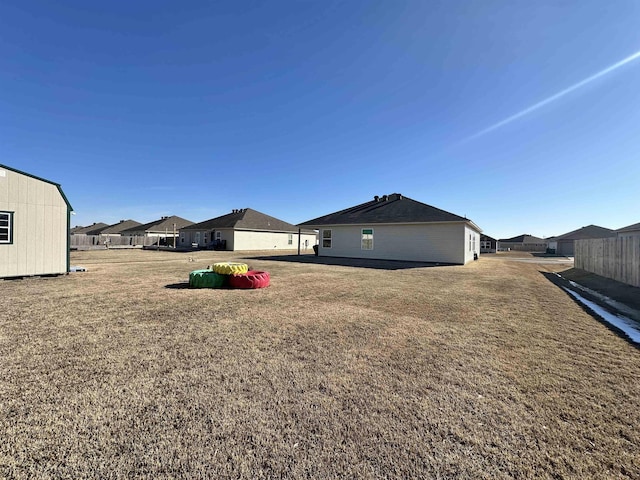 view of yard with fence and a residential view