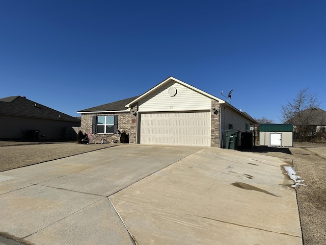 single story home featuring a garage, concrete driveway, and brick siding